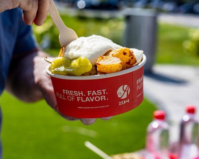 Amir food photography showing a rolled pita sandwich.